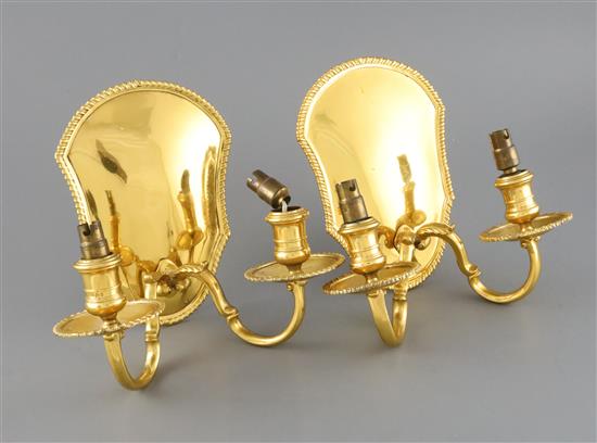 A matched pair of George V silver gilt two branch, two light wall sconces,